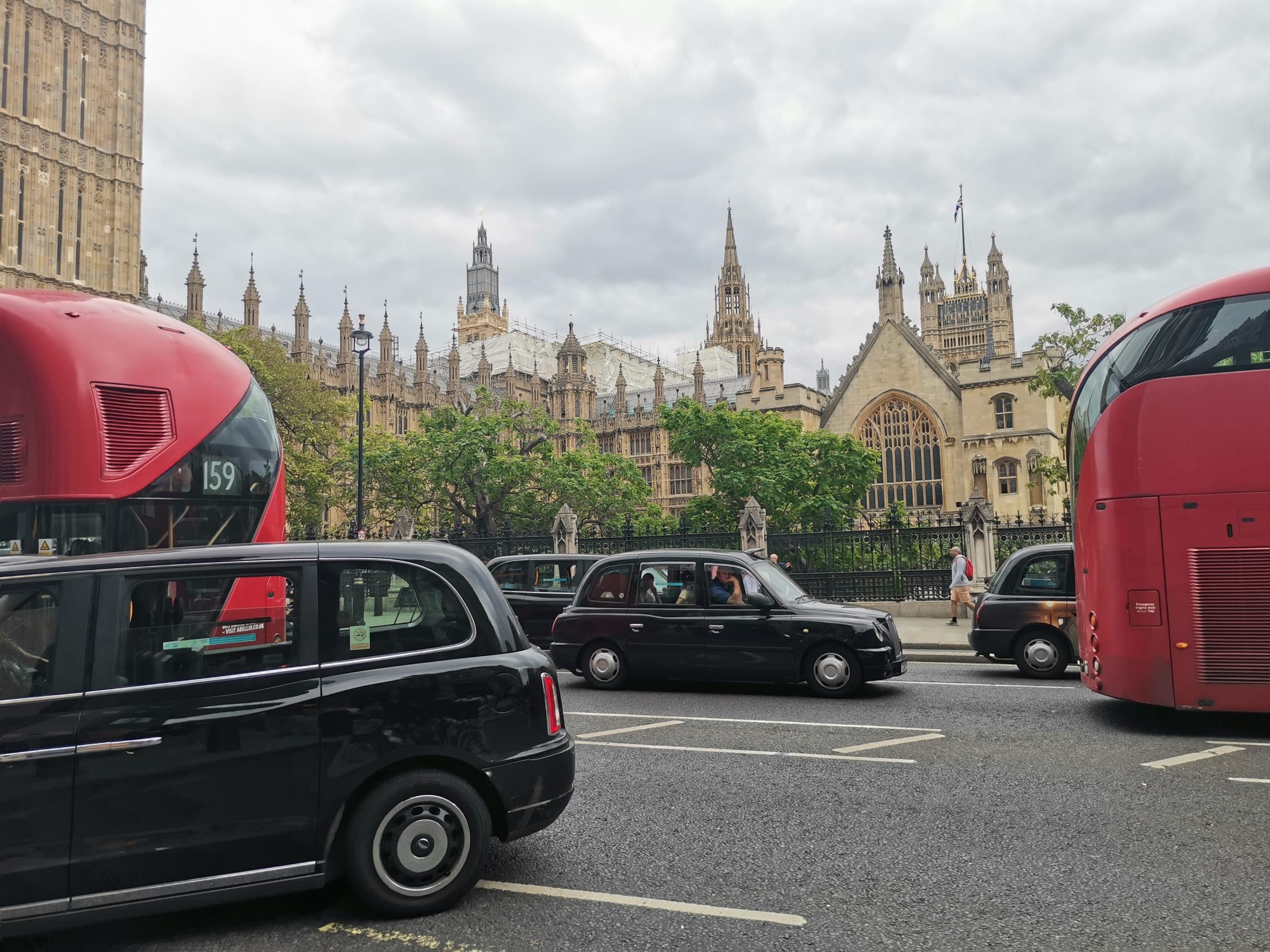 Parliament, a red bus and a black cab