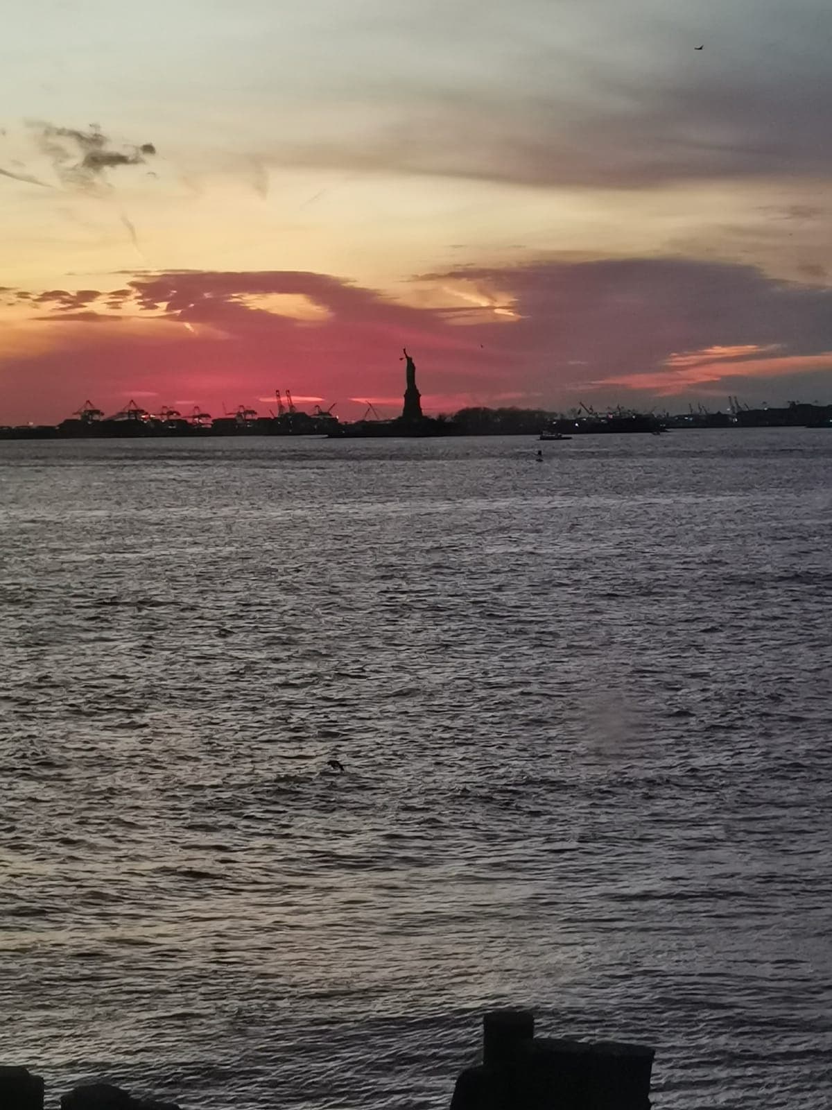 4:37 pm. From the Staten Island Ferry, the Statue of Liberty at sunset.