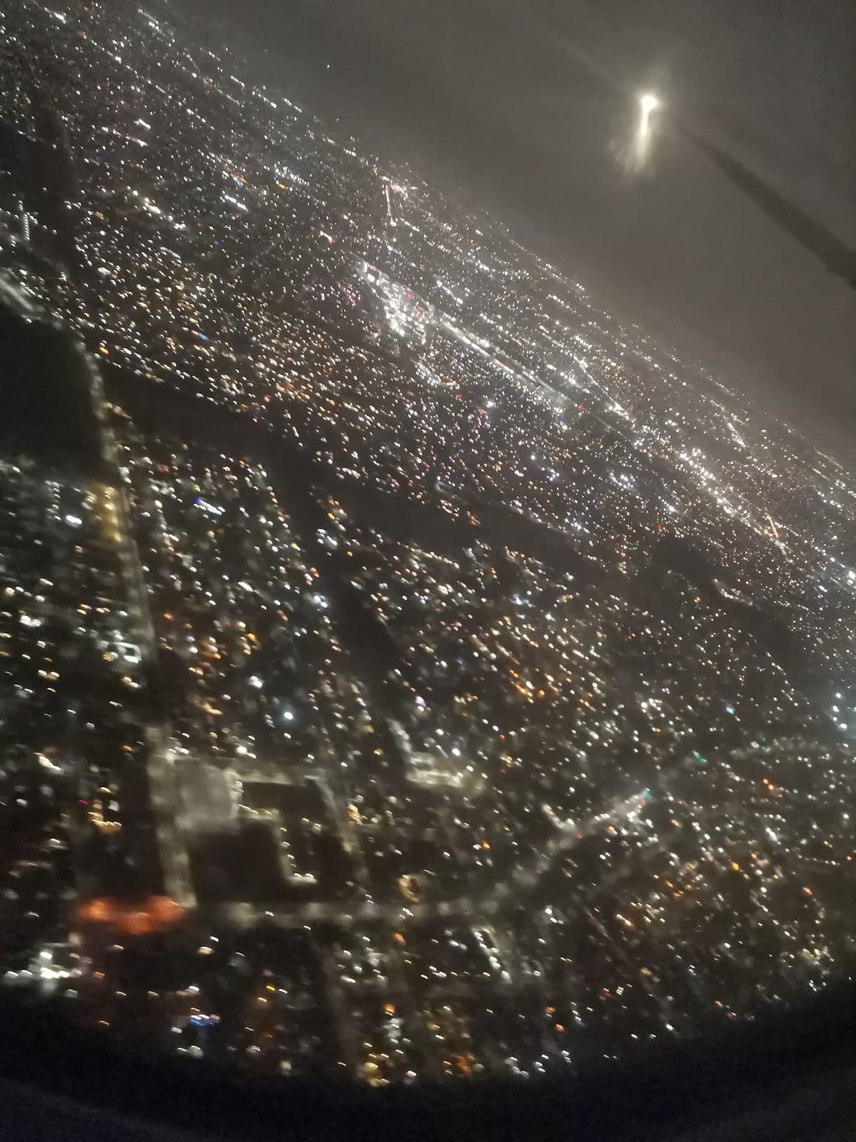 The next night, 9:38 pm. New York under the plane, one last time.